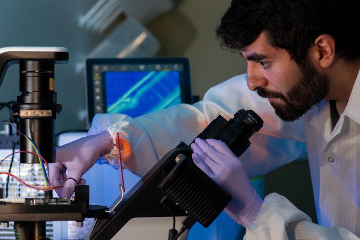 A researcher holding a microscope