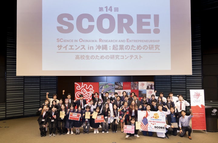 Students on the stage pausing for a photo