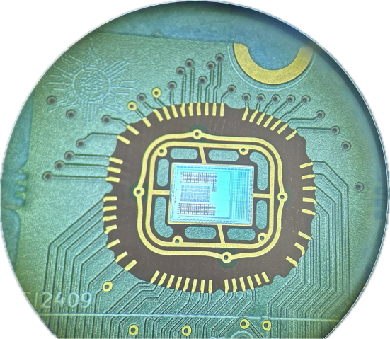 A photo of a computing chip, shown in greens, blues and golds.