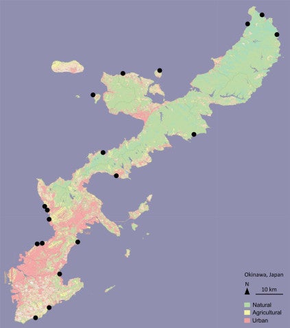 A map of Okinawa is colored red, yellow and green to represent urban, agricultural and natural land respectively. Black dots represent sampling sites.