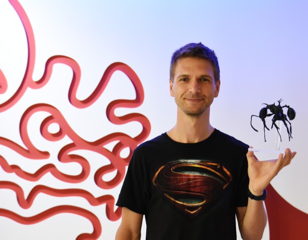 Dr. Georg Fischer, OIST post-doctoral scholar, holding an enlarged 3D printed version of Pheidole drogon
