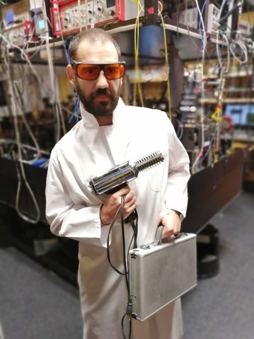 Scientist holding experimental silver equipment