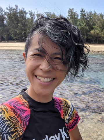 A lady smiling on the beach