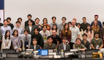 Participants from OIST and Keio University pose together for a group photo at the OIST-Keio Showcase Talk Series Vol. 10, standing at the front of a seminar room.
