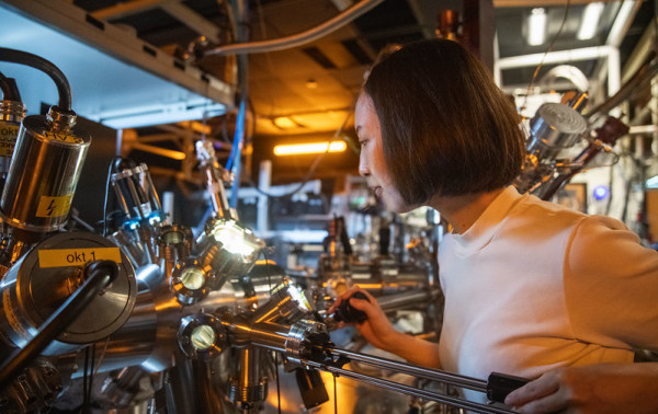 A researcher working in a lab in front of a machine