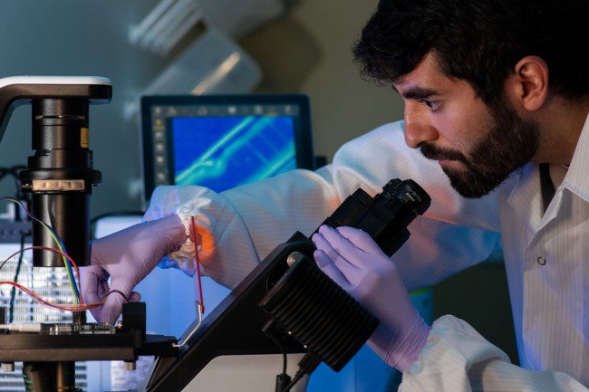 A researcher holding a microscope