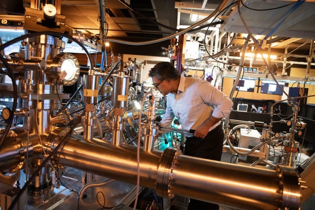 A researcher operating a lab machine
