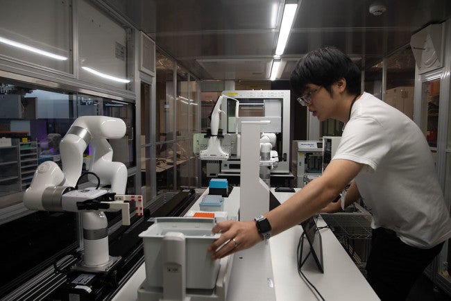 A researcher operating a lab equipment