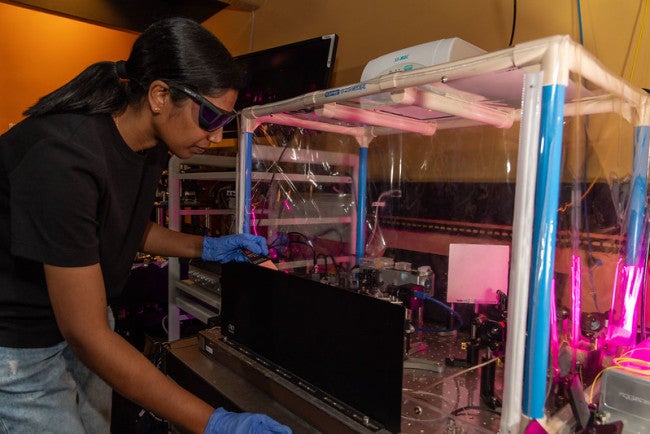 a researcher working with a lab machine