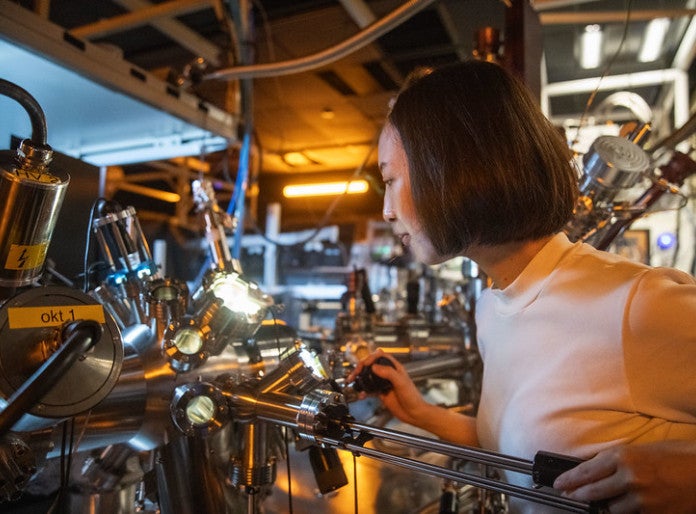 A researcher working in a lab in front of a machine