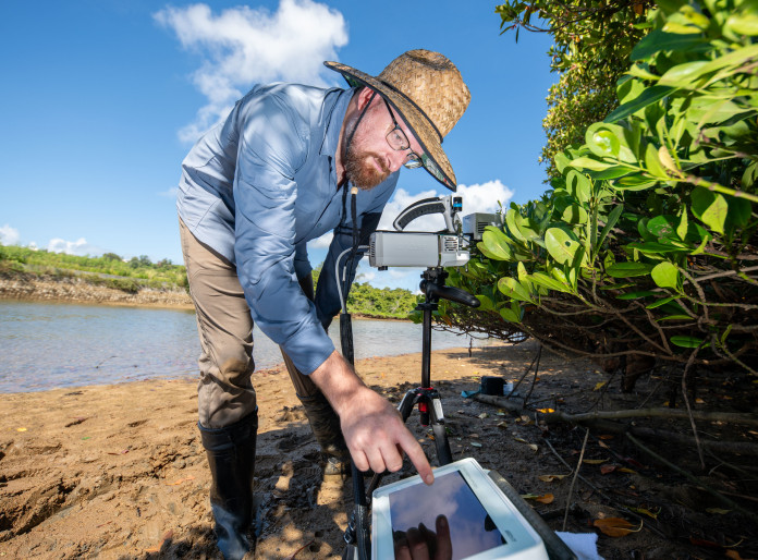 David Armitage at the beach working with research equipment